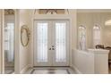 Elegant entryway with ornate glass double doors and arched transom window at 6919 Dominion Ln, Lakewood Ranch, FL 34202