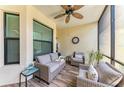 Relaxing screened balcony with comfortable seating and a ceiling fan at 7315 River Hammock Dr # 101, Bradenton, FL 34212