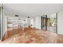 Bright room with terracotta tile and sliding doors to an outdoor area adjacent to the all-white kitchen at 754 Pine Run Dr # 754, Osprey, FL 34229