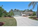 Charming single-story home with landscaped front yard, palm tree, attached garage and long concrete driveway at 7817 Pine Trace Dr # 15, Sarasota, FL 34243