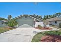 Charming single-story home with landscaped front yard, palm tree, attached garage and concrete driveway at 7817 Pine Trace Dr # 15, Sarasota, FL 34243
