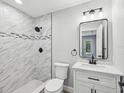 Updated bathroom with tiled shower, modern vanity, and sleek fixtures offering a clean aesthetic at 8304 Fishhawk Ave, New Port Richey, FL 34653