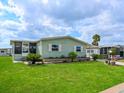 Well-maintained home featuring a lush lawn and complemented by vibrant greenery and landscaping at 8400 Princess Ct, Palmetto, FL 34221