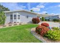 Immaculate front yard with colorful landscaping and a compass decoration, enhancing curb appeal at 8439 Imperial Cir, Palmetto, FL 34221