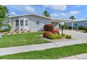Well-manicured lawn and landscaping highlight this home's exterior, complete with a covered carport at 8439 Imperial Cir, Palmetto, FL 34221