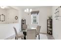 Bright dining room with a glass table, gray chairs, and modern decorative accents at 8445 Starlight Loop, Parrish, FL 34219