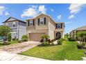 Charming two-story home features landscaped yard, brick driveway, and attached garage at 11430 Gallatin Trl, Parrish, FL 34219