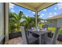 Covered patio seating area with wicker furniture and outdoor view at 11430 Gallatin Trl, Parrish, FL 34219