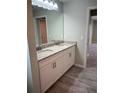 Bathroom featuring double sink vanity with granite countertop and white cabinets at 12089 Mayfair Ave, Port Charlotte, FL 33981