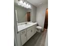 Modern bathroom boasts a marble countertop vanity, updated fixtures, and a tile floor at 12127 Storke Ave, Port Charlotte, FL 33981