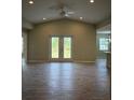 Spacious living room with vaulted ceilings, tile floors, and sliding glass doors to the backyard at 12127 Storke Ave, Port Charlotte, FL 33981