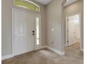 Bright foyer featuring tile floors, a white front door with a window, and an open entryway at 1657 Bonita Bluff Ct, Ruskin, FL 33570
