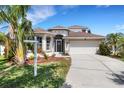 Charming two-story home featuring a two-car garage and tropical landscaping in a desirable neighborhood at 1657 Bonita Bluff Ct, Ruskin, FL 33570