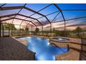 Inviting screened-in pool area with a hot tub, perfect for relaxation and outdoor enjoyment at 1657 Bonita Bluff Ct, Ruskin, FL 33570