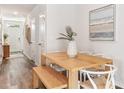 Bright dining area featuring a wooden table with a bench, stylish chairs and decor at 17429 Haysack Ter, Lakewood Ranch, FL 34211