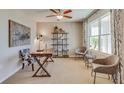 Comfortable office featuring neutral paint, ceiling fan, and rustic wooden desk with stylish black and white chair at 18223 Wheathouse Pl, Lakewood Ranch, FL 34211