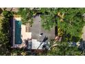 Aerial view of the home, highlighting the backyard pool and mature trees at 1830 Virginia Dr, Bradenton, FL 34205