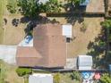 Birds-eye view of a property with a brown roof and backyard featuring mature trees and outdoor amenities at 1856 Wharf Rd, Sarasota, FL 34231