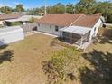 An aerial of a backyard with a screened-in porch and a storage shed; a mix of grassy and bare patches at 1856 Wharf Rd, Sarasota, FL 34231