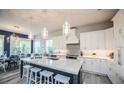 Gourmet kitchen with center island, breakfast bar, stainless appliances, and stylish pendant lighting at 212 72Nd, Holmes Beach, FL 34217