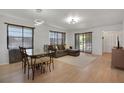 Spacious living room featuring modern lighting and an attached dining area at 2415 Bayshore Gardens Pkwy # 8, Bradenton, FL 34207