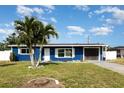 Charming curb appeal with well-maintained lawn and blue exterior on this cozy single-Gathering home at 3095 Pinetree St, Port Charlotte, FL 33952