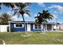 Charming curb appeal with well-maintained lawn and blue exterior on this cozy single-Gathering home at 3095 Pinetree St, Port Charlotte, FL 33952