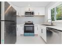 Updated kitchen features stainless steel appliances, white cabinets and lots of counter space at 3095 Pinetree St, Port Charlotte, FL 33952