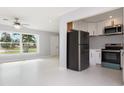 The living room has a large window that lets in natural light at 3095 Pinetree St, Port Charlotte, FL 33952