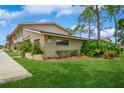 Townhouse exterior featuring well-manicured lawn, exterior stucco, and manicured landscaping at 3610 54Th W St # B4, Bradenton, FL 34209