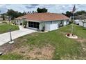 Well-maintained home featuring a screen lanai, white privacy fence, and manicured lawn at 3984 Holin Ln, North Port, FL 34287
