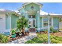 Inviting front entrance with decorative landscaping, mature plants, and decorative exterior lights at 425 46Th Nw St, Bradenton, FL 34209