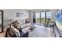 Comfortable living room showcasing contemporary decor and sliding glass doors opening to a balcony with a view at 4801 Osprey S Dr # 405, St Petersburg, FL 33711