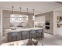 Modern kitchen featuring a large island with seating, designer pendant lighting, and stainless steel appliances at 555 Quay Cmn # 804, Sarasota, FL 34236