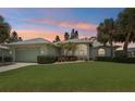 Charming single Gathering home with well-manicured lawn, landscaping and two-car garage at 5596 Sabal Trace Dr, North Port, FL 34287