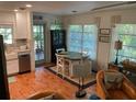 Charming dining area with views of the outdoors, next to the kitchen with lots of natural light at 590 Artists Ave, Englewood, FL 34223