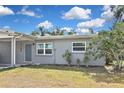 Home featuring a well-maintained lawn, and freshly painted exterior with new energy efficient windows at 5905 Olive Ave, Sarasota, FL 34231