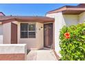 Attractive townhome facade highlighting the front door and lush tropical foliage at 6010 36Th Avenue W Cir # E, Bradenton, FL 34209