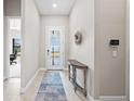 Elegant foyer with a neutral color palette, stylish console table, and a welcoming front door at 6244 Talon Preserve Dr, Nokomis, FL 34275
