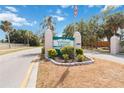 Community sign with a well-maintained landscape and an American flag waving in the breeze at 6615 12Th Ave W W Ave, Bradenton, FL 34209