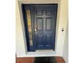 Stylish navy front door with sidelight and secure smart lock at 6711 Cambridge Park Dr, Apollo Beach, FL 33572