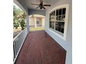 Inviting covered porch with brick flooring and ceiling fan at 6711 Cambridge Park Dr, Apollo Beach, FL 33572