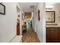 Inviting hallway with wood-look flooring, leading to the bathroom and showcasing the house's layout at 7907 4Th W Ave # 7907, Bradenton, FL 34209