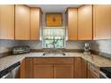 Bright kitchen featuring granite countertops, stainless steel sink, and neutral-tone cabinetry at 7907 4Th W Ave # 7907, Bradenton, FL 34209