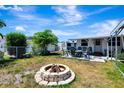 Spacious backyard with a fire pit, ideal for entertaining and enjoying outdoor gatherings at 997 28Th Avenue E Dr, Bradenton, FL 34208