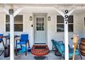 Cozy front porch featuring a comfortable seating area and decorative lighting, perfect for enjoying the outdoors at 997 28Th Avenue E Dr, Bradenton, FL 34208