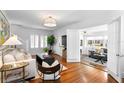 Bright living room featuring hardwood floors, large windows with shutters, and an open layout at 1140 Oak Ne St, St Petersburg, FL 33701