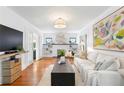 Bright living room featuring hardwood floors, neutral furnishings, and a brick fireplace at 1140 Oak Ne St, St Petersburg, FL 33701