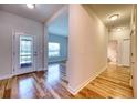 Entryway showcasing stylish wood-look flooring, a modern front door, and natural lighting at 11924 Persian Ter, Bradenton, FL 34212