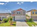 Charming two-story home with a well-manicured lawn, landscaping, and inviting curb appeal at 13013 Oak Hill Way, Parrish, FL 34219